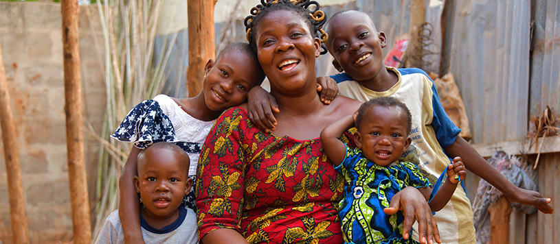 a mother sits with her children