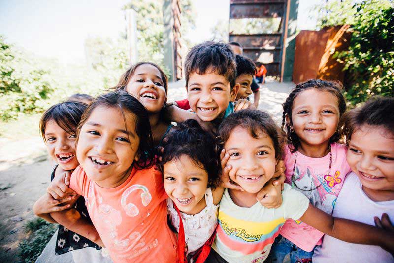 A group of children play together in their neighborhood